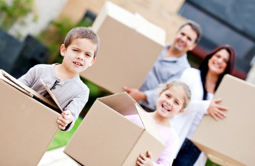 House removalists delivering boxes and furniture to a new home