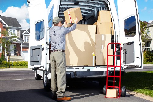 Professional movers packing fragile household items