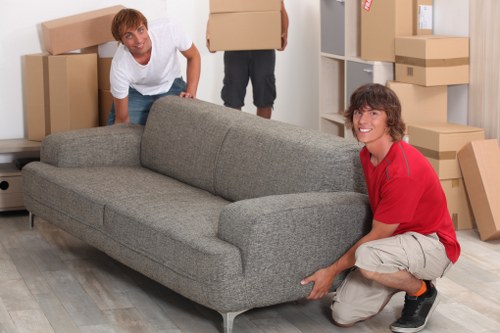 Moving crew handling stairs in a North London property